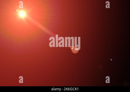 Lens flare and light beam on dark background orange color style. Abstract Natural Sun flare on black. Lens Flare ,Sun Flare on black background. Lens Stock Photo