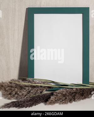 Green Frame mock up and dried natural pampas grass. Interior decoration element. Flatlay top view. Background boho. Minimalism design. Copy space. ver Stock Photo