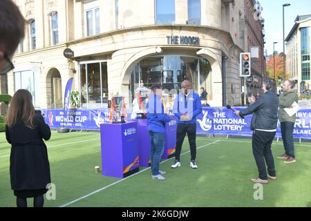 14/10/2022 Bi-stander tries to steal the Rugby League World Cups during an interview held by ITV local news on Newcastle Quayside, UK Stock Photo