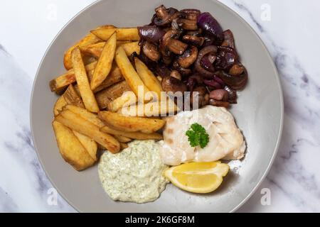 Baked cod loin, skin on chips, sauteed mushroom and red onion, tartare sauce, seen from above Stock Photo