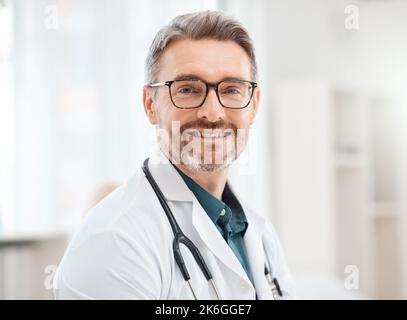 White coat hero. Portrait of a mature doctor working in a clinic. Stock Photo