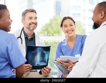 Everyones voices gets heard. a group of medical practitioners analysing x-rays in a hospital. Stock Photo