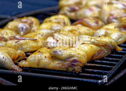 Chicken on a barbecue at the Mountains of Fire Timanfaya national park resort on Lanzarote, Canary Islands, Spain. Barbequing chicken from the heat of Stock Photo