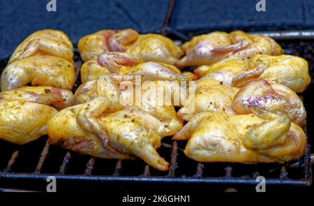 Chicken on a barbecue at the Mountains of Fire Timanfaya national park resort on Lanzarote, Canary Islands, Spain. Barbequing chicken from the heat of Stock Photo