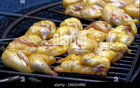 Chicken on a barbecue at the Mountains of Fire Timanfaya national park resort on Lanzarote, Canary Islands, Spain. Barbequing chicken from the heat of Stock Photo