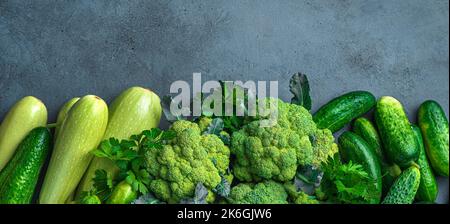 Fresh vegetables and greens on a dark background. Assortment of vegetables. Stock Photo