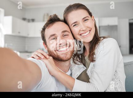 Orange you glad you met me. Portrait of a young couple relaxing on a sofa at home. Stock Photo