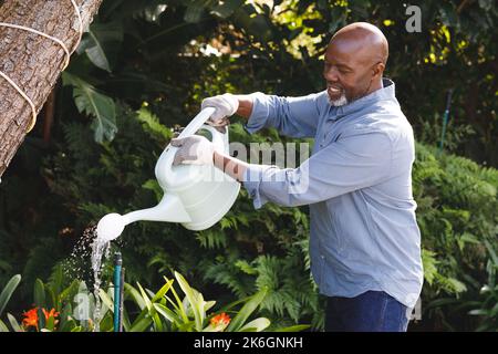 Happy senior african american man working in garden Stock Photo