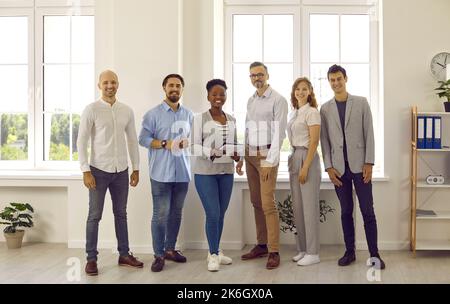 Group portrait of team of joyful successful and intelligent multiracial business colleagues. Stock Photo