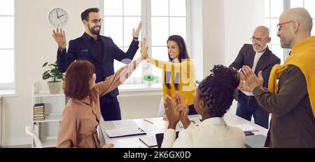 Two happy successful business women give each other high five after job well done. Stock Photo