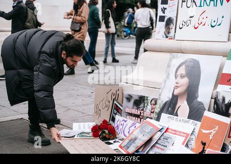 New York, United States. 01st Oct, 2022. Supporter places his protest sign next to the memorial to Mahsa Amini in New York's Washington Square Park. Woman, Life, Freedom protest against Iran's hardline Islamic regime held in New York. Protests broke out after Mahsa Amini's death in the custody of Iran's so-called moral police. Credit: SOPA Images Limited/Alamy Live News Stock Photo