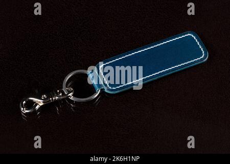 Leather keychain on a dark background. Stock Photo