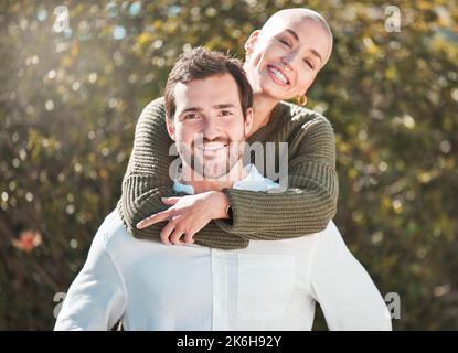 My partner in life. Cropped portrait of a handsome young man piggybacking his wife outdoors. Stock Photo