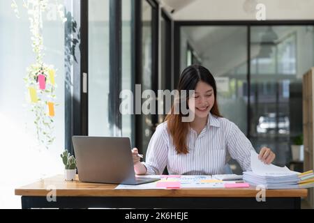 Accounting planning budget concept - Business woman offices working for arranging documents unfinished stack of document papers Stock Photo