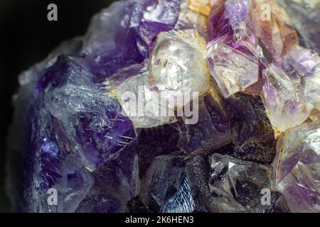 Ultra macro close up of a natural purple Amethyst quartz cluster isolated on black background Stock Photo