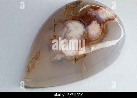 Flower dendritic agate chalcedony cabochon gem on white background macro Stock Photo