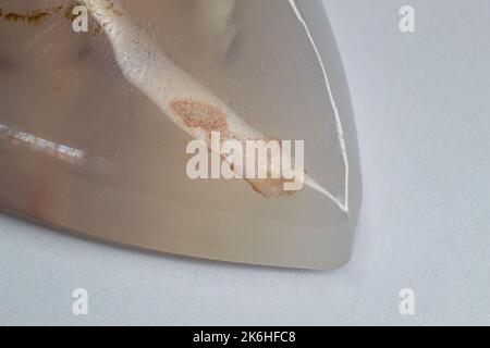 Flower dendritic agate chalcedony cabochon gem on white background macro Stock Photo
