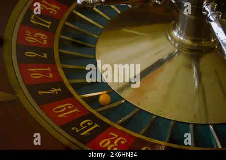 Antique casino roulette with the ball on the red 19 Stock Photo