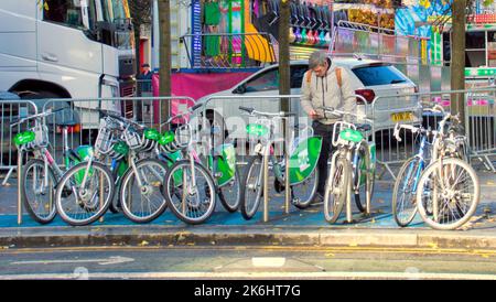 Glasgow, Scotland, UK  14th October,  2022. UK Weather:  Wet and dry day saw people struggle on the street amidst the economic crisis.  Nextbike ovo bikes are gaining popularity in the city under the autumn colour. Credit Gerard Ferry/Alamy Live News Stock Photo