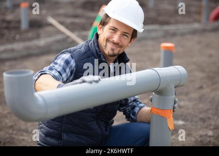 home renovation plumber fixing sewerage pipe Stock Photo