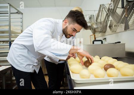 portrait of workers at a chocolate egg factory Stock Photo