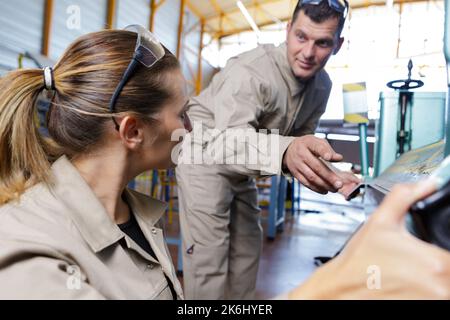two factory workers are talking Stock Photo