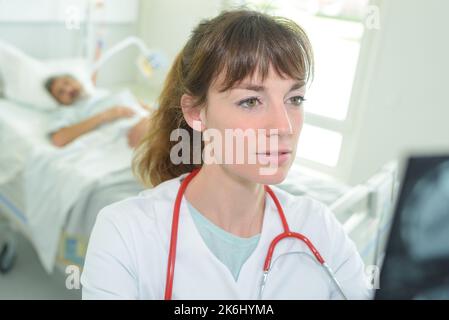 woman doctor walking in office with clipboard Stock Photo