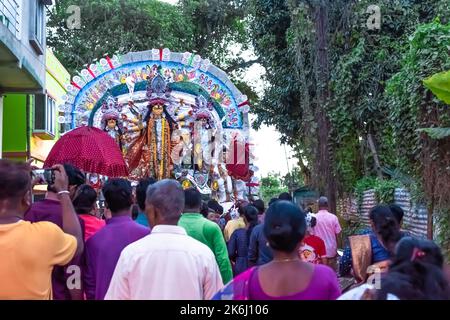 Devotees immerse Durga Idol on River Ganges during the last day of Durga Puja festival . Stock Photo