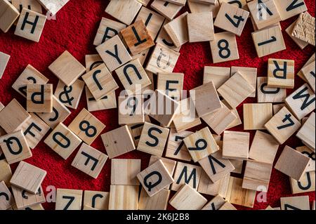 Black letters placed on wood. Small pieces of alphabet. Stock Photo