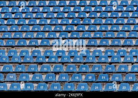 Tribune sports stadium, blue chairs arranged in rows Stock Photo