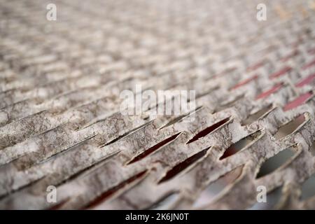 Perforated metal sheet stamping plates texture angled view. Made through metal stamping sheet metal manufacturing lightweight elements to combine Stock Photo