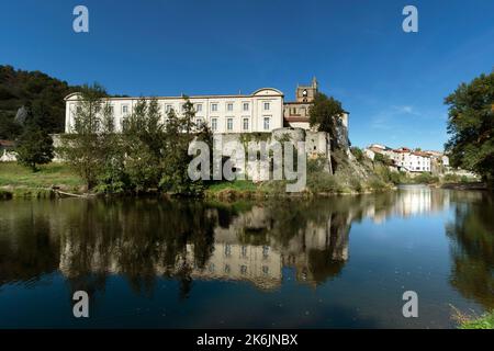 Lavoute Chilhac labelled Les Plus Beaux Villages de France.Priory Sainte-Croix reflecting in the river Allier, Haute-Loire, Auvergne-Rhone-Alpes.France Stock Photo
