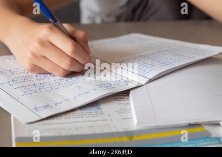 Child affected by dyslexia doing homework, reading book using colorful overlay strip. Education, learning disability, reading difficulties concept Stock Photo