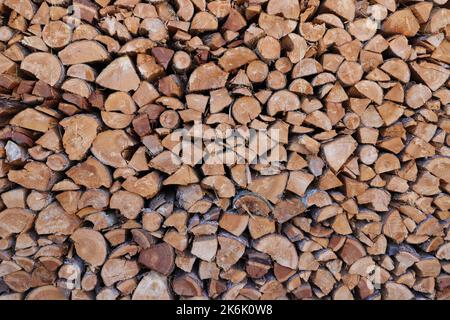 stacked dry firewood as a background Stock Photo