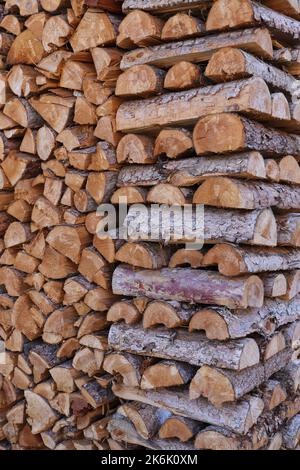 stacked dry firewood as a background Stock Photo