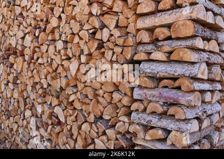 stacked dry firewood as a background Stock Photo