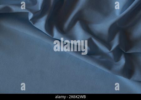 Abstract crumpled linen fabric texture background. Natural blue color dyed linen organic eco textiles canvas background. Top view Stock Photo