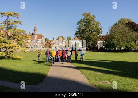 Salisbury Wiltshire, uk, 10, October, 2022 international tourists on the cathedral green in salisbury, with Sarum College in the background Stock Photo