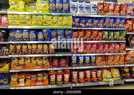 Shelves with selection of crisp packs in a Tesco supermarket, London England United Kingdom UK Stock Photo