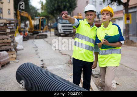 Two qualified engineers are discussing a construction plan Stock Photo