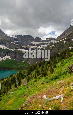 Photograph of the the Garden Wall and the shrinking Grinnell Glacier from the Grinnell Glacier Trail on an overcast day. Glacier National Park, Montan Stock Photo