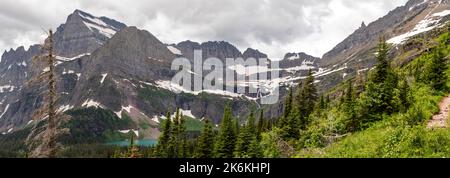 Photograph of the the Garden Wall and the shrinking Grinnell Glacier from the Grinnell Glacier Trail on an overcast day. Glacier National Park, Montan Stock Photo