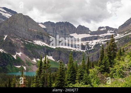 Photograph of the the Garden Wall and the shrinking Grinnell Glacier from the Grinnell Glacier Trail on an overcast day. Glacier National Park, Montan Stock Photo