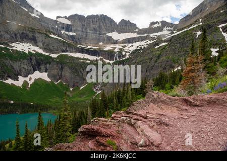 Photograph of the the Garden Wall and the shrinking Grinnell Glacier from the Grinnell Glacier Trail on an overcast day. Glacier National Park, Montan Stock Photo