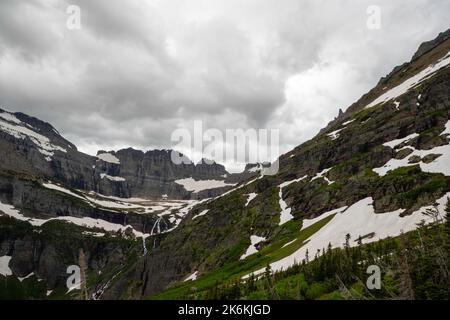 Photograph of the the Garden Wall and the shrinking Grinnell Glacier from the Grinnell Glacier Trail on an overcast day. Glacier National Park, Montan Stock Photo