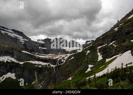 Photograph of the the Garden Wall and the shrinking Grinnell Glacier from the Grinnell Glacier Trail on an overcast day. Glacier National Park, Montan Stock Photo