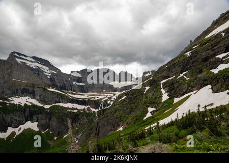 Photograph of the the Garden Wall and the shrinking Grinnell Glacier from the Grinnell Glacier Trail on an overcast day. Glacier National Park, Montan Stock Photo