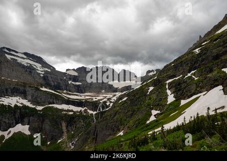 Photograph of the the Garden Wall and the shrinking Grinnell Glacier from the Grinnell Glacier Trail on an overcast day. Glacier National Park, Montan Stock Photo