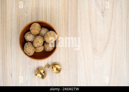 Hazelnuts in a bowl on the table. Flat lay. Stock Photo