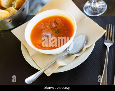 Close-up of tomato gazpacho soup in bowl topped with ice cubes Stock Photo